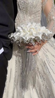 a bride and groom holding their wedding bouquet