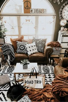 a living room filled with lots of furniture and decor on top of a white rug