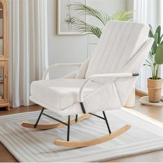 a white rocking chair sitting on top of a rug