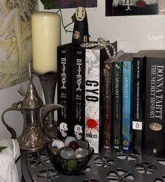 some books and a candle on a table