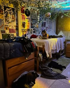 a woman laying on top of a bed in a bedroom next to a pile of clothes