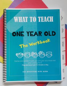 the workbook for what to teach one year old is on top of colorful papers