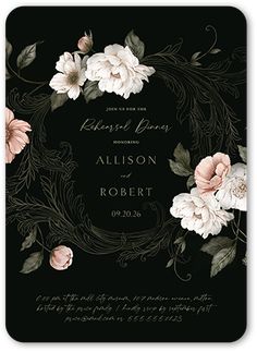 a black and white wedding card with pink flowers on the front, surrounded by greenery