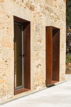 two open windows on the side of a stone building