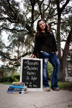 a woman standing next to a chalkboard sign