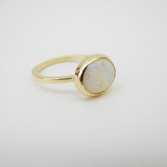 Yellow Gold Polished Opal Ring, 14k Gold Opal Ring With Polished Finish For Promise, 14k Gold Stackable Opal Promise Ring, Minimalist Ring With Polished Round Stone, Minimalist Rings With Polished Round Stone, Minimalist White Rings With Polished Finish, Modern 14k Gold Oval Opal Ring, 14k Gold Opal Ring With Polished Finish, Fine Jewelry 14k Gold Opal Ring With Polished Finish