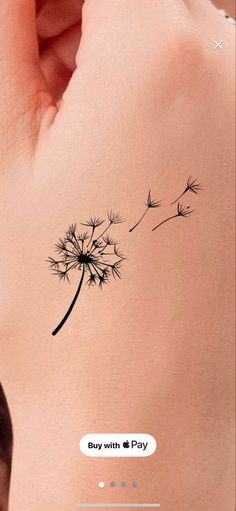 a dandelion tattoo on the back of a woman's left arm, with text that reads buy with 1 pay