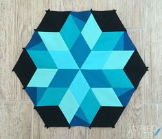 a blue and black patchwork design on a wood floor