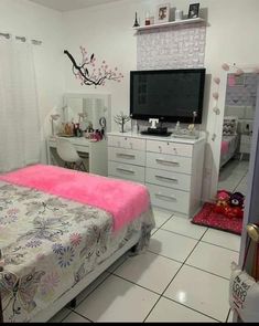 a bedroom with a bed, dresser and television