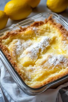 a lemon dessert in a glass dish with powdered sugar on top