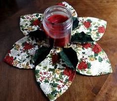 a glass with some liquid in it sitting on top of a flower shaped place mat