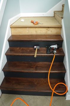 an orange cord is on top of some stairs