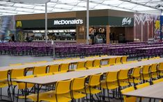 tables and chairs are lined up in front of mcdonald's