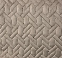 a close up view of a quilted material with an interesting pattern on the fabric