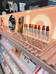 there are many different types of cosmetics on display in the store, including lip glosses and eyeliners