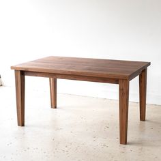 a wooden table sitting on top of a white floor