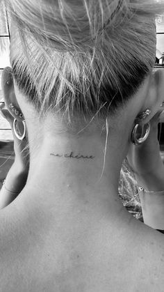 a woman with a small tattoo on her neck