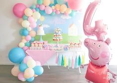 a birthday party with balloons, cake and balloon arch in the shape of a hippo