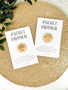 the pocket prayer pins are sitting on top of a woven place mat next to a plant