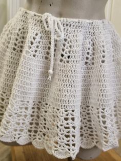 READY TO SHIP  THIS LISTING IS FOR THE SKIRT ONLY. White boho style crochet skirt with lacy detail. Perfect addition  to your summer wardrobe.  Made from light weight 60% acrylic 40% nylon.  THS CROCHETED ITEM CAN STRETCH Up to 2.5 to 3 inches or up to 8cm.  Size: size 8 to 12  in Australian sizes. ACTUAL GARMENT MEASURES Waist:  72 cm or 28 inches Skirt length:  approx  32cm or 12.5 inches FIND MORE SKIRTS HERE: https://www.etsy.com/your/shops/me/tools/listings/section:41188597,sort:title,order:ascending,stats:true MODEL'S MEASUREMENTS:   Bust- 87cm. Under bust - 72cm Waist - 62cm All items listed in my store are a finished product and are ready to be shipped immediately.   MADE IN A SMOKE FREE ENVIRONMENT 😊 Please comment, like or share My store and products on your socials.  Your suppo Crochet Skirt Beach, White Crochet Skirt, Crochet Mini Skirt, Skirt Crochet, Skirt Beach, Skirt Summer, Beach Skirt, Crochet Skirt, Boho Crochet