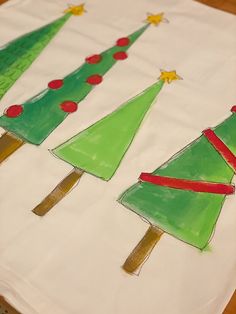 three handmade christmas trees on a white napkin