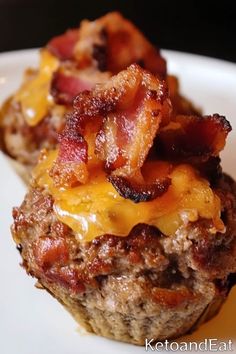 two bacon and cheese muffins on a white plate