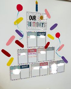 a birthday calendar hanging on the wall with balloons