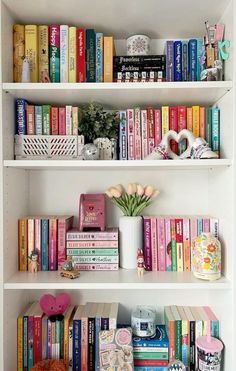 the bookshelves are filled with many different types of books and vases on them