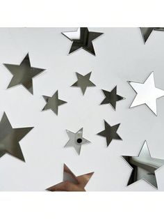 several metal stars are flying in the air