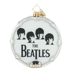 an ornament with the beatles on it's front and back sides, hanging from a chain