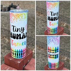 two tumbles that have been painted with different colors and designs, one has the words tiny human tamen on it