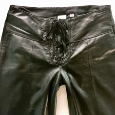 "Vintage 90's black leather motorcycle pants Tied closure Fixed polyester insulated lining Exterior is in excellent condition with minimal wear Interior is in great condition Labels are intact Name on label - Wilsons Leather Maxima Size on label - 10 Approximate Measurements: Waist 32\" Upper Thigh 23\" Inseam 34\" Rise 9\" All measurements are taken seam to seam while laying flat. Once the item is in your cart you may select the shipping method that works best for you. Here at This Vinyl Life, Lace Up Leather Pants, Leather Motorcycle Pants, Pants With Lace, Sleeveless Turtleneck Top, Biker Pants, Motorcycle Pants, Black Leather Pants, Leather Pant, Leather Motorcycle Jacket