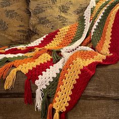 a crocheted afghan is draped on a couch