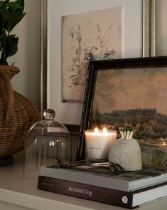 a couple of candles sitting on top of a book