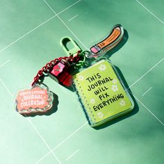 a keychain that says, this journal must fix everything on the floor next to it