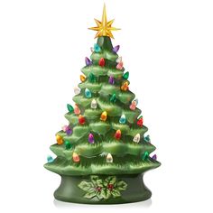 a green ceramic christmas tree with lights on it