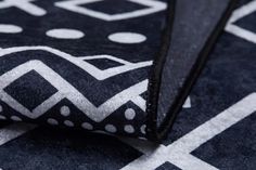 a black and white area rug with polka dot design on the bottom, close up