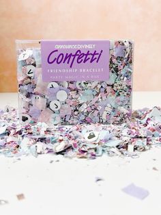 confetti party mix in a box on a table with scattered confetti