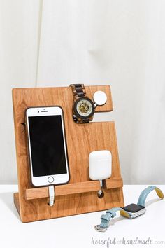 a cell phone is plugged in to a charger on a wooden docking stand