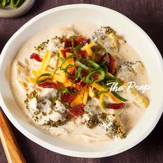 a white bowl filled with food on top of a table