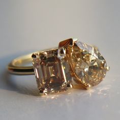 two yellow and white diamond rings sitting on top of each other