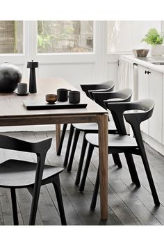 a dining table with six chairs around it