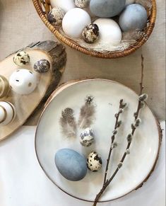 two baskets filled with eggs sitting next to each other on top of a white table