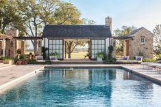 an outdoor pool surrounded by chairs and tables