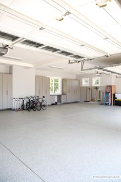 an empty garage with several bikes parked in the space next to it and storage cabinets on either side