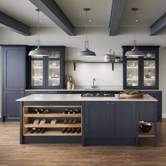 a kitchen with blue cabinets and wooden floors