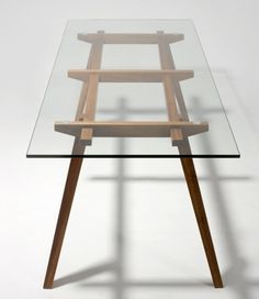 a glass table with wooden legs and a wood frame on top, against a white background