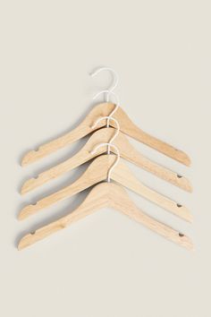 four wooden hangers on a white background