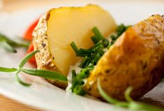 a close up of a plate of food with potatoes and vegetables on it's side