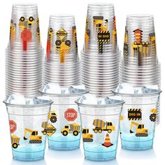 there are many cups with construction themed designs on them and one is filled with water